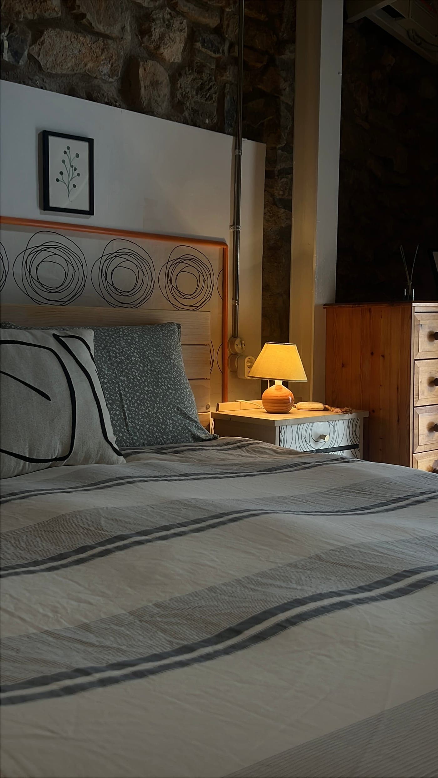 La cama doble con la lámpara de noche encendida